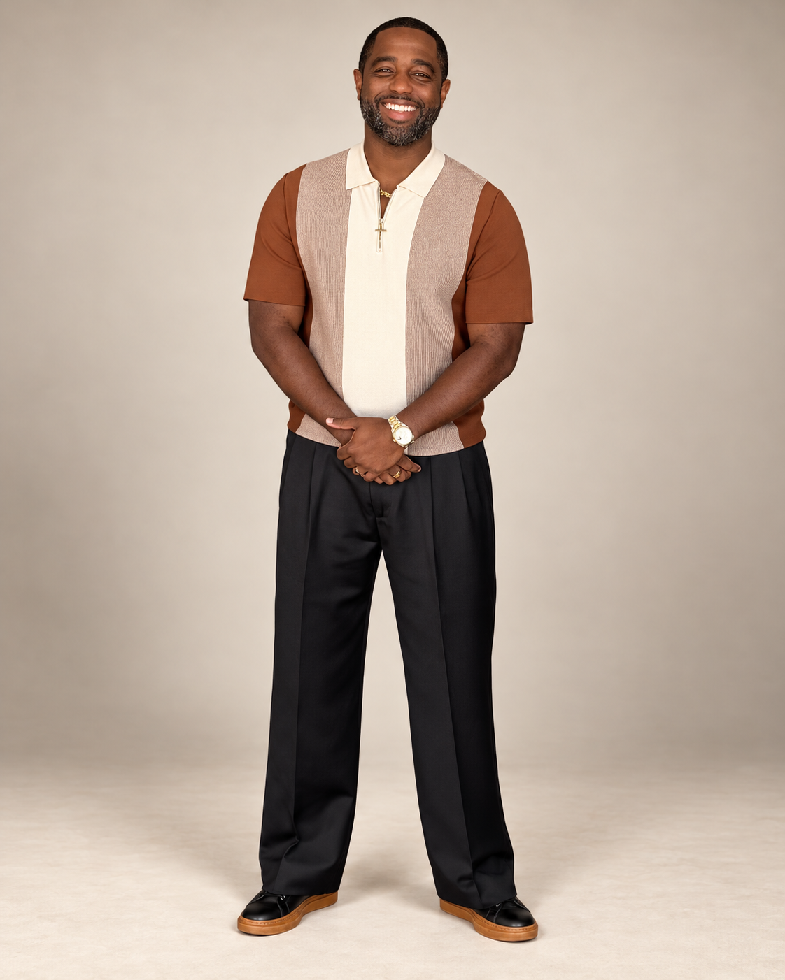 Tony A. Gaskins Jr. standing in a warm ivory studio, smiling